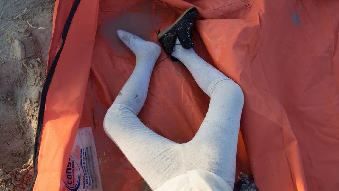 In this Tuesday, Sept 1. 2015, photo, the body of a child, who washed up along with others, is seen in Zuwara, Libya (65 miles west of Tripoli) after two smuggling boats sank off the coast of Libya last Thursday.
