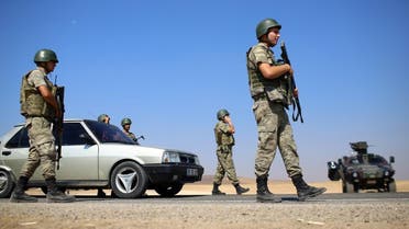 Turkish soldiers take position on a road near Suruc on the border with Syria. (AP Photos)