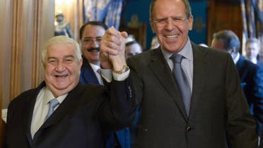 Russian Foreign Minister Sergey Lavrov, right, and Syrian Foreign Minister Walid al-Moallem enter a hall hand in hand for their talks in Moscow, Russia, Friday, Jan. 17, 2014. The Syrian authorities are ready to pool efforts with the opposition to fight terrorists, Muallem said in Moscow on Friday. (AP Photo/Pool)