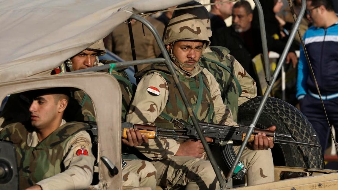 Egyptian military police stand guard at the Almaza military airport where the bodies of soldiers who died in overnight attacks in north Sinai ap