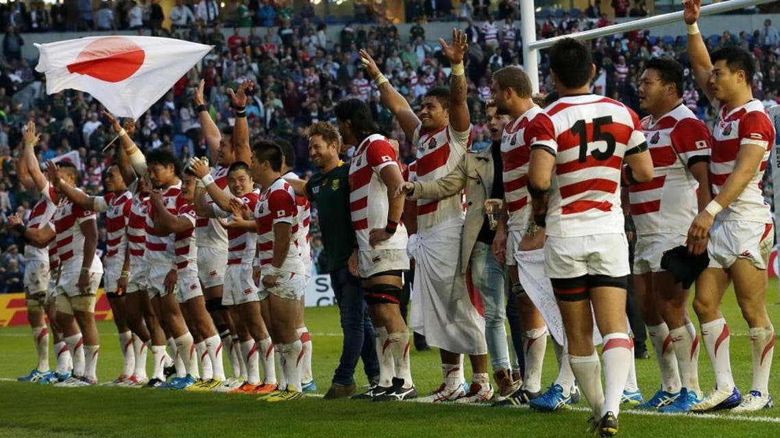 Japan teammates celebrates with the crowd after defeating South Africa 32-34 in the Rugby World Cup Pool B match at the Brighton Community Stadium, Brighton, England Saturday, Sept. 19, 2015. (AP Photo/Tim Ireland)
