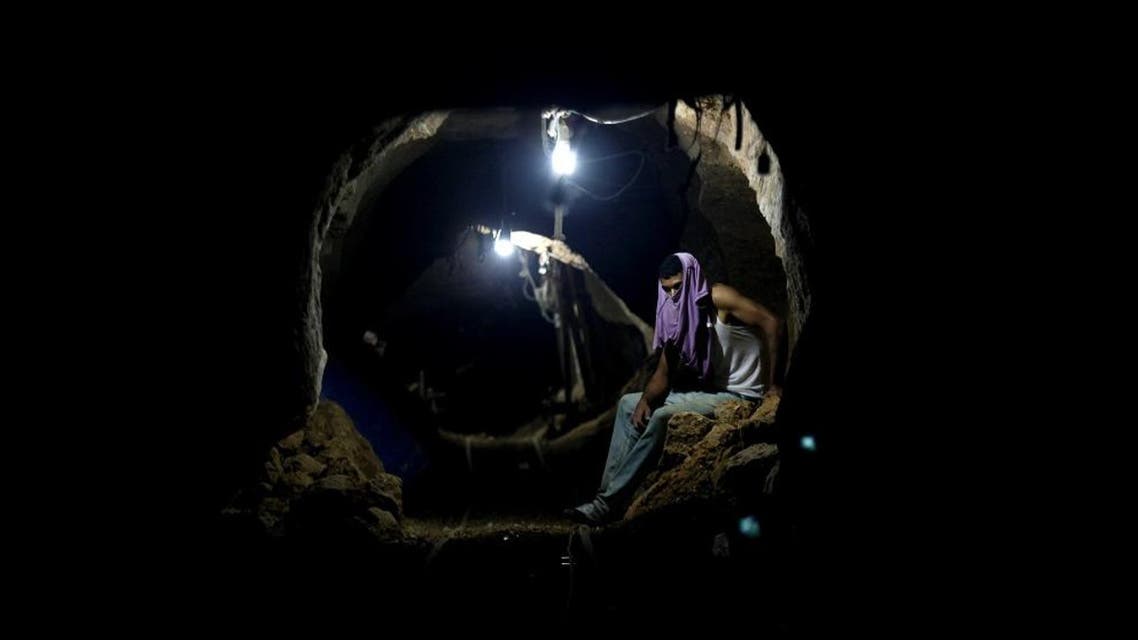 Palestinian worker rests inside a smuggling tunnel in Rafah, on the border between Egypt and the southern Gaza Strip. (File: AP)