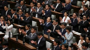  In this Saturday, Sept. 19, 2015 file photo, Japan’s ruling party lawmakers applaud after contentious legislation was passed in a vote by the upper house of Parliament in Tokyo. In the wee hours of Saturday morning, Japan took a step toward having a military in line with most armed forces around the world, one that would be able to take part in combat even when the country is not under direct attack. While Japan’s military remains far from unfettered, the package of bills approved by parliament is a further step in a gradual erosion of the restrictions that has been underway for more than two decades. (AP Photo/Koji Sasahara, File)
