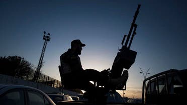 A Libyan army soldier stands guard sitting on an antiaircraft truck. (Reuters) 