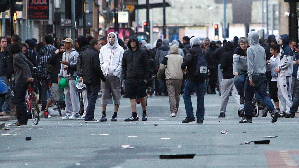 A file photo showing crowds standing in a Manchester street during the 2011 riots. (AP)