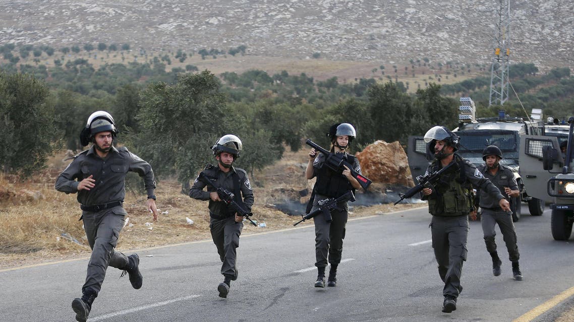 Israeli border police run during clashes with Palestinian stone-throwers following the funeral of Palestinian Riham Dawabsheh at Duma village, near the occupied West Bank city of Nablus, September 7, 2015. The mother of a Palestinian toddler killed in a July arson attack in the Israeli-occupied West Bank, died on Monday of her burns, the third fatality after her husband succumbed to his injuries last month. Suspected Jewish attackers torched the family's home in the northern West Bank on July 31, killing the 18-month-old boy, Ali. His father Saad Dawabsheh died on Aug. 9 and his mother Riham, 27, four weeks later. REUTERS/Ammar Awad
