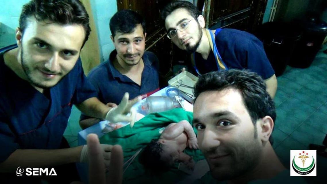 SEMA doctors taking a picture with the new born baby girl after removing the shrapnel from her brow. (Photo courtesy: Facebook/SEMA)