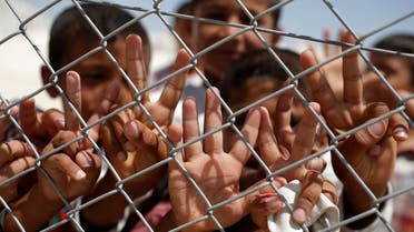  Syrian refugee children wave and flash the V-sign at a refugee camp in Suruc, on the Turkey-Syria border, Friday, June 19, 2015. Ahead of World Refugee Day on Saturday, June 20, 2015, the UN refugee agency, UNHCR, estimated that a total of 11.6 million people from Syria had been displaced by the conflict by the end of last year, the largest such figure worldwide. Turkey is the world's biggest refugee host with 1.59 million refugees, according to the most recent U.N. figures. (AP Photo/Emrah Gurel)
