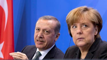  German Chancellor Angela Merkel, right, listens as Turkey's Prime Minister Recep Tayyip Erdogan, left, speaks during a joint press conference after a meeting at the chancellery in Berlin, Germany, Tuesday, Feb. 4, 2014. (AP Photo/Axel Schmidt)