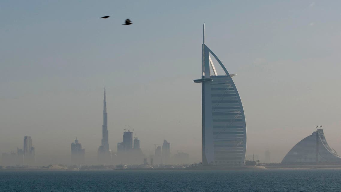 The Burj al-Arab as see from the Palm Jumeirah in Dubai. The Burj Khalifa, the world's tallest building, can be seen in the distance (Reuters)