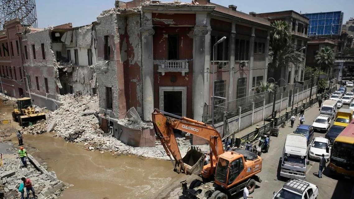 Workers clear rubble at the site of an explosion near the Italian Consulate in downtown, Cairo, Egypt, Saturday, July 11, 2015. AP