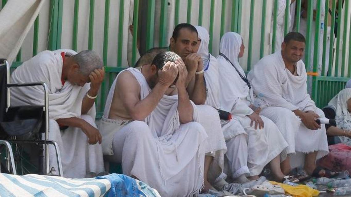 Pilgrims sit on the side walk in grief near the site of the stampede. (Essa Al-Dobisi/Al Arabiya)