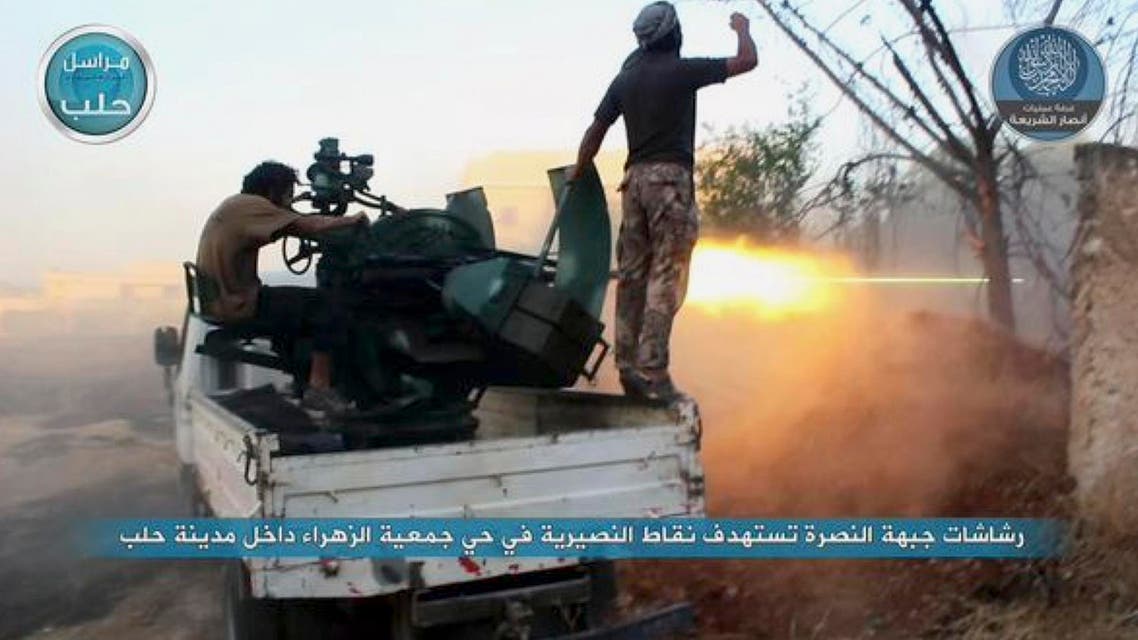 In this image posted on the Twitter page of Syria's al-Qaida-linked Nusra Front on early Tuesday, July 7, 2015, fighters from the Nusra Front fire their weapons against the Syrian government forces at the western Zahra neighborhood in Aleppo city, Syria. Opposition fighters and Islamic militants have launched a series of attacks in Aleppo since last week, capturing the city's Scientific Research Center that was used as a military base. Activists said Syrian troops and pro-government gunmen have been trying to retake the base with no luck so far. (Al-Nusra Front via AP)