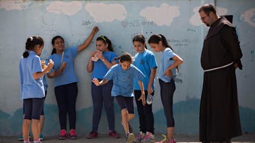  FILE - In this Tuesday, May 26, 2015 file photo, Arab Israeli Christian school children play at the Terra Santa School in the mixed Jewish-Arab city of Ramle, Israel. About 2,500 striking demonstrators gathered Sunday, Sept. 6, 2015, outside the prime minister’s office in Jerusalem, police said, to protest against the slashing of funds for Christian schools. Christian school administrators accuse Israel of cutting their funding as a tactic to pressure them to join the Israeli public school system _ a move they say would interfere with the schools' Christian values and high academic achievements. (AP Photo/Oded Balilty, File)