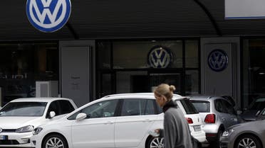 A woman walks by a Volkswagen dealer in Milan, Italy, Sunday, Sept. 27, 2015.  (AP)