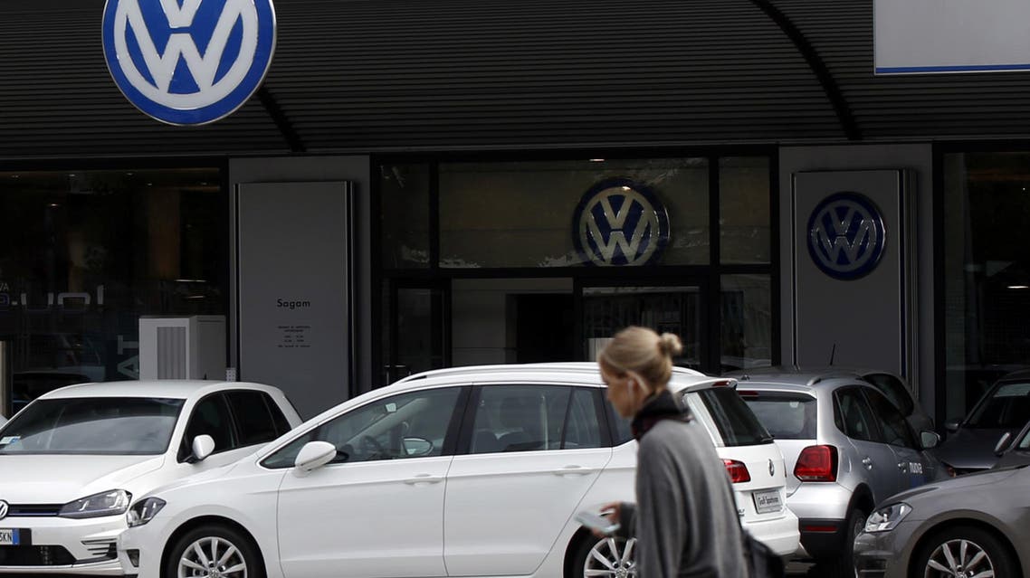 A woman walks by a Volkswagen dealer in Milan, Italy, Sunday, Sept. 27, 2015. (AP)