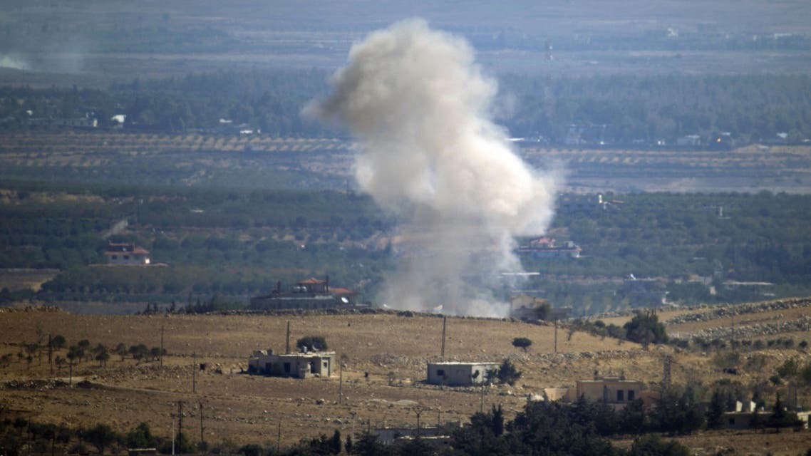 JAM03 - Buqaata, GOLAN HEIGHTS, - : Seen from the hill village of Buqaata in the Israeli-annexed Syrian Golan Heights, smoke ascends from alleged shelling by Syrian government forces in the Syrian village of Jubata al-Khashab, on September 27, 2015. AFP PHOTO/JALAA MAREY