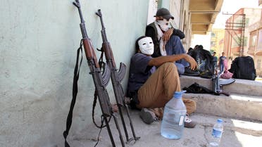 Masked members of YDG-H, youth wing of the outlawed Kurdistan Workers Party (PKK), sit next to their weapons in Silvan, near the southeastern city of Diyarbakir, Turkey, in this August 17, 2015 file photo. Young, urban-based fighters, many of them still teenagers, have taken centre-stage in the conflict between Kurdish militants and Turkish security forces that has flared anew in southeast Turkey since a two-year ceasefire fell apart in July. The intensity of the violence recalls for some the 1990s, when the insurgency waged by the PKK was at its peak and thousands were being killed annually, though the death toll remains for now well below those levels. The fighters from the PKK's youth wing, known as the 'Patriotic Revolutionary Youth Movement' (YDG-H), attack security forces in cities and towns with heavy weapons, dig trenches and erect barricades down side streets. REUTERS/Sertac Kayar/Files