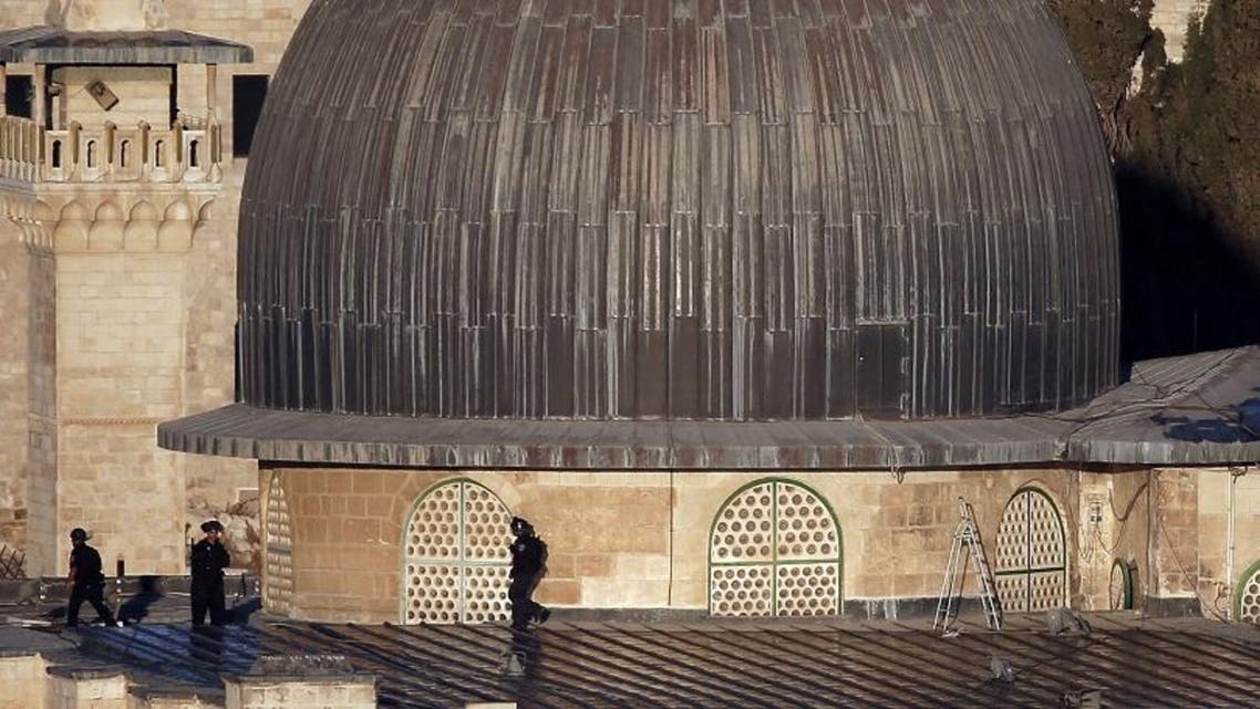 Israeli security forces stand guard at one of the main entrances of the Al Aqsa mosque as Palestinians throws firebombs from inside the mosque. (AFP)