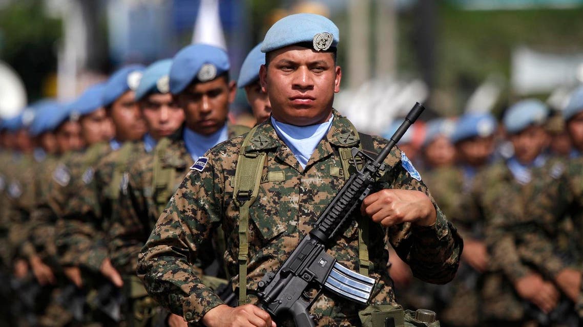 Salvadoran members of the United Nations peacekeepers and army soldiers march in the parade commemorating Soldiers' Day in San Salvador, El Salvador, Saturday May 7, 2011