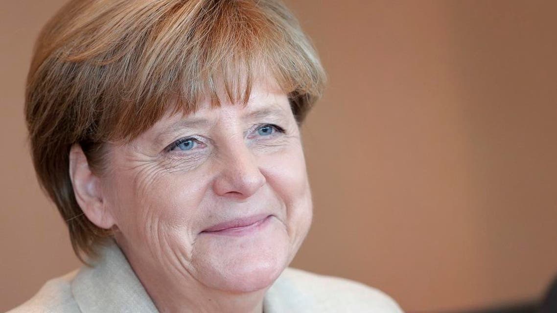 German Chancellor Angela Merkel smiles as she arrives for the weekly cabinet meeting in Berlin, Germany, Tuesday, Sept. 29, 2015. (AP Photo/Michael Sohn)