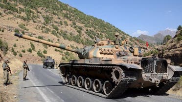 Turkish soldiers in a tank and an armored vehicle patrol on the road to the town of Beytussebab in the southeastern Sirnak province, Turkey. (File: Reuters)