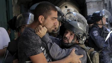 An Israeli policeman prevents a Palestinian man from entering in Occupied Jerusalem's Old City. (Reuters)