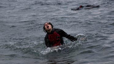 A Syrian refugee splashes in the water as he approaches the shores of Lesbos island after jumping from a inflatable dinghy that carried him with others from Turkey to Greece on Wednesday, Sept. 23, 2015. More than 260,000 asylum-seekers have arrived in Greece up to this point, most reaching the country's eastern islands on flimsy rafts or boats from the nearby Turkish coast. (AP Photo/Petros Giannakouris)