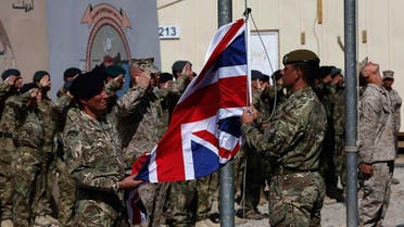 British troops lower the Union flag during a ceremony marking the end of operations for US and British combat troops in Helmand province, Afghanistan. (Reuters)