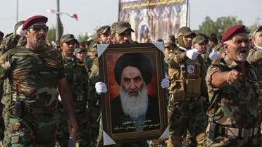  Members of the Abbas combat squad, a Shiite militia group, carry a picture of spiritual leader Grand Ayatollah Ali al-Sistani during a parade in Basra, 340 miles (550 kilometers) southeast of Baghdad, Iraq, Saturday, Sept. 26, 2015. Iraqi security forces and allied Shiite militias are training together to try to regain Iraqi cities under Islamic State control, officials said. (AP Photo/Nabil al-Jurani)