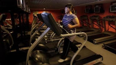 A woman runs on a treadmill as part of her training during a six-week programme in an exercise room at the Bodyworks weight loss campus in Beijing August 26, 2011. (Reuters)