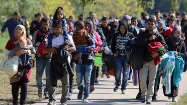  Migrants walk to the border between Hungary and Austria in Hegyeshalom, Hungary, Thursday, Oct. 1, 2015. The European Union is threatening to take action against Hungary over laws it has introduced to limit the flow of migrants through its territory. (AP Photo/Ronald Zak)