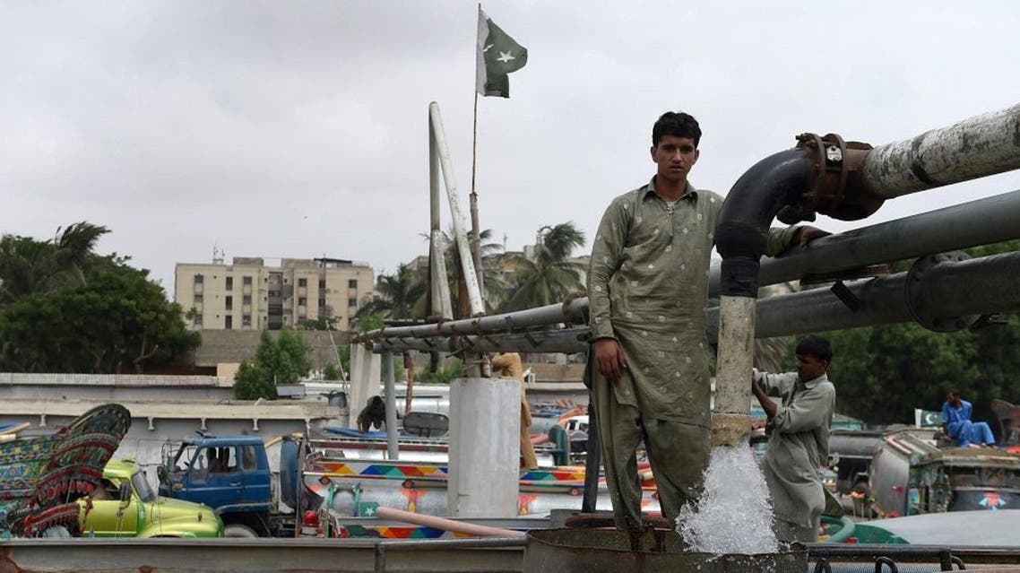 In this photograph taken on August 22, 2015, Pakistani employees fill water tankers at a government hydrant to provide residential areas in Karachi.