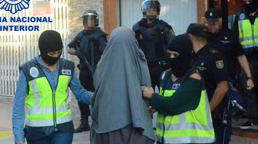  This handout image released on October 4, 2015 by the Spanish Interior Ministry shows a person suspected of belonging to a "network of recruitment, indoctrination," for "sending foreign fighters to fight for Daesh (Islamic State) in the regions of Syria and Iraq", being led away after arrest by Spanish authorities at an unspecified location on October 4, 2015. Police have arrested 10 people in Spain and Morocco for allegedly recruiting and indoctrinating fighters for the Islamic State group, the Spanish interior ministry announced today.