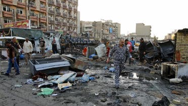Residents look at wreckage at the site of a car bomb attack in Baghdad, Iraq. (File: Reuters)