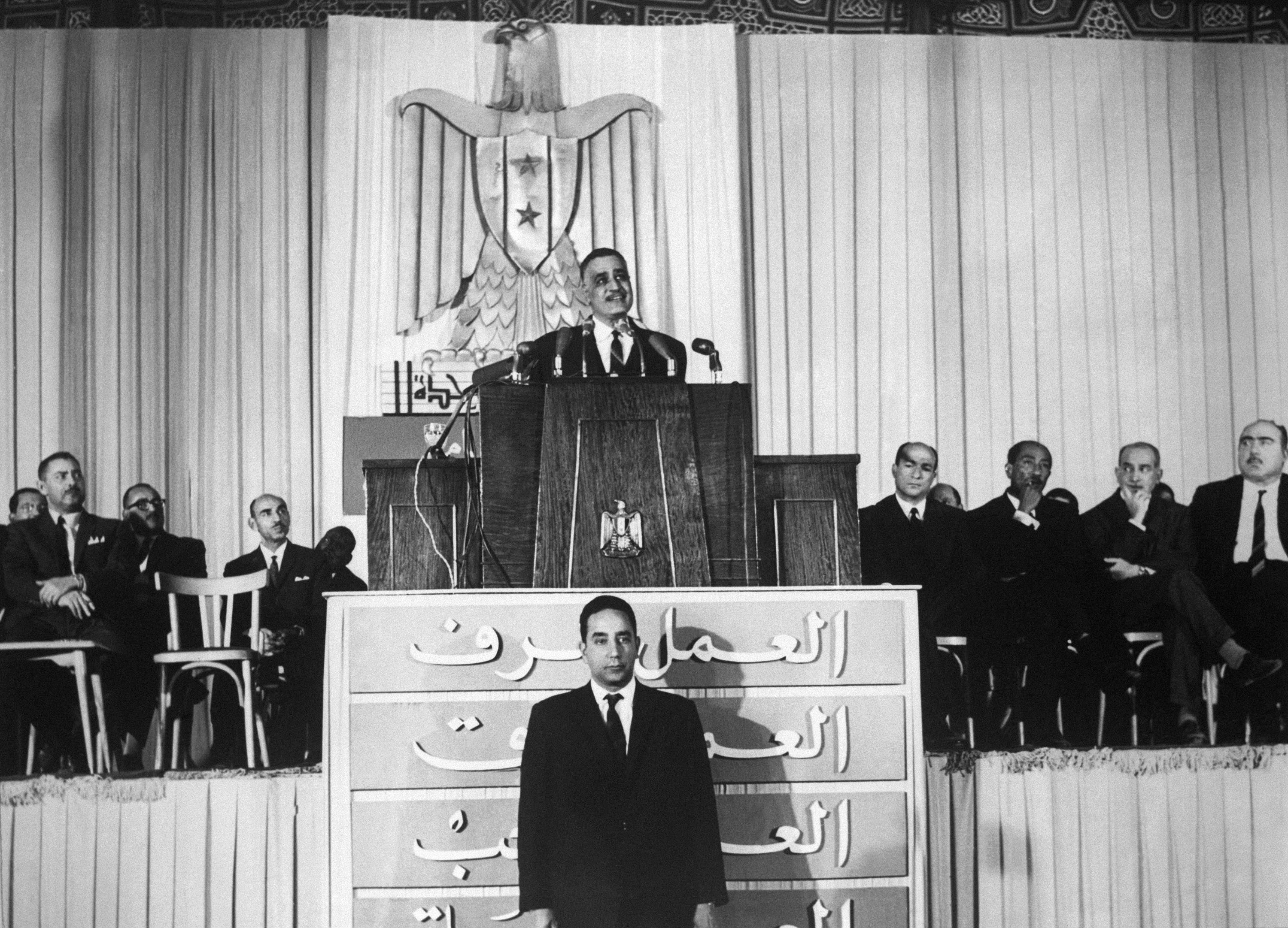 Egypt's President Gamal Abdel Nasser seen making a speech in 1968. His sucessor, Anwar Sadat can be seen second from right (AP)