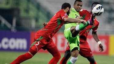 Rashed Hassan Ali Hassan from Al Shabab Al Arabi of the UAE, middle, fights for the ball with Majed Rafa Alamri, left, from Al Ettifaq of Saudi Arabia during a AFC Champions League match in Dubai, United Arab Emirates, Wednesday, April 3, 2013. (AP)