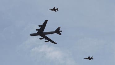  A U.S. strategic bomber B-52 and two Jordanian F-16 aircraft participate in 18-nation military exercises in a field near the border with Saudi Arabia, in Mudawara, 280 kilometers (174 miles) south of Amman, Jordan, Monday, May 18, 2015. Some 10,000 troops took part in the two-week "Eager Lion" exercises hosted by Jordan for the fifth year. (AP Photo/Raad Adayleh)