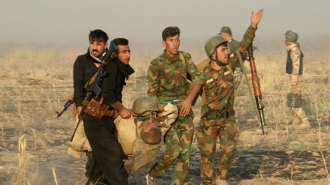 An injured Kurdish officer is taken for treatment, during a military operation to regain control of some villages from Islamic State group fighters south of oil-rich city of Kirkuk, 180 miles (290 kilometers) north of Baghdad, Iraq, Wednesday, Aug. 26, 2015. (AP Photo)