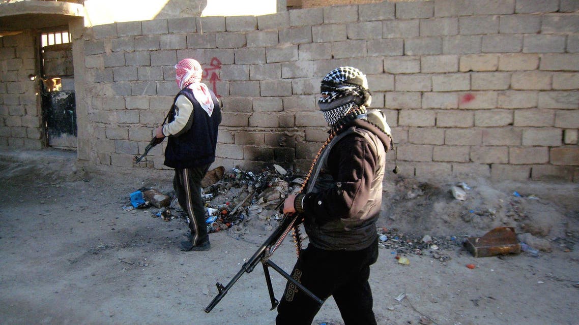 In this Wednesday, Feb. 12, 2014 photo, masked anti-government gunmen hold their weapons as they patrol Fallujah, Iraq. The situation deteriorated significantly in late December, when security forces dismantled a protest camp near the Anbar provincial capital of Ramadi. To defuse tensions, security forces withdrew from Ramadi and the nearby city of Fallujah. Al-Qaida-linked militants promptly took over parts of Ramadi and the center of Fallujah. Since then, the government and allied tribes have been struggling to wrest control of the cities back from the militants. Al-Qaida-led militants are battling for control of mainly Sunni areas to the west of the Iraqi capital in a key test of the Shiite-led government's ability to maintain security in the country more than two years after the withdrawal of U.S. troops. (AP Photo)