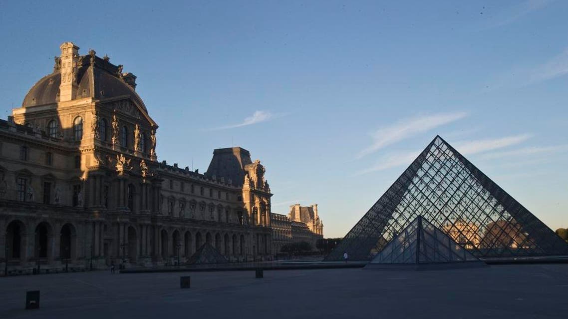 The Louvre museum is seen at sunrise in Paris, Tuesday, Oct. 14, 2014. AP