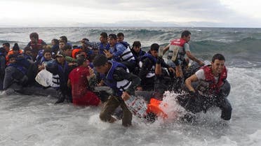 Refugees and migrants struggle to jump off an overcrowded dinghy on the Greek island of Lesbos, after crossing in rough seas from the Turkish coast, October 2, 2015. REU