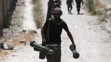 A fighter from the Free Syrian Army's Al Rahman legion carries a weapon as he walks towards his position on the front line against the forces of Syria's President Bashar al-Assad in Jobar, a suburb of Damascus. (File photo: Reuters)