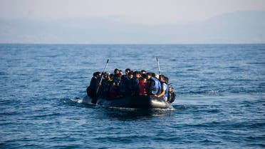 Migrants arrive in an overloaded rubber dinghy at the coast near Skala Sikaminias, Lesbos island. (AP)