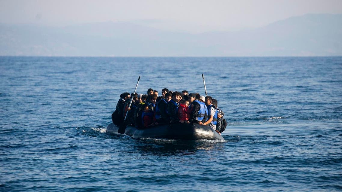 Migrants arrive in an overloaded rubber dinghy at the coast near Skala Sikaminias, Lesbos island. (AP)