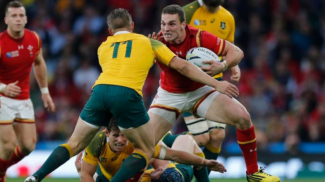 Wales' George North is tackled by Australia's Drew Mitchell during the Rugby World Cup Pool A match between Australia and Wales at Twickenham Stadium, London, Saturday, Oct. 10, 2015. (AP Photo/Frank Augstein)