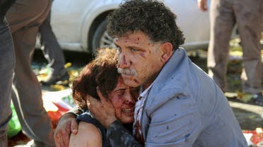 An injured man hugs an injured woman after an explosion during a peace march in Ankara. (Reuters)