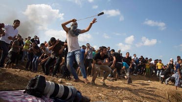 A Palestinian protester hurls stones at Israeli soldiers during clashes on the Israeli border Eastern Gaza. (AP)