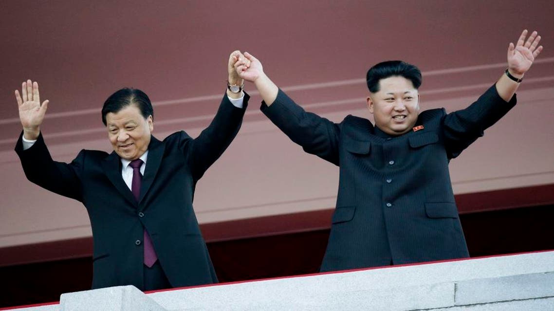 North Korean leader Kim Jong Un, right, stands with visiting Chinese official Liu Yunshan during a parade in Pyongyang, North Korea, Saturday, Oct. 10, 2015. North Korean leader Kim Jong Un declared Saturday that his country was ready to stand up to any threat posed by the United States as he spoke at a lavish military parade to mark the 70th anniversary of the North's ruling party and trumpet his third-generation leadership. (AP Photo/Wong Maye-E)
