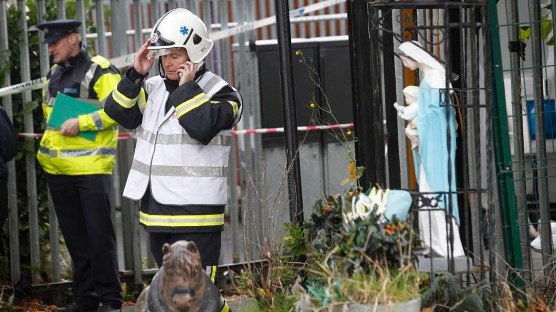 Emergency services attend the scene of a fire in Carrickmines, Dublin, Ireland, Saturday, Oct. 10, 2015. Police say nine people, including an infant, have died in a fire at a mobile home camp for Ireland’s native Gypsies. Detectives say they have yet to establish a cause for Saturday’s fire at a Dublin council-run housing site for Irish Gypsies, who in Ireland are known as ``travelers.’’ (AP Photo/Peter Morrison)